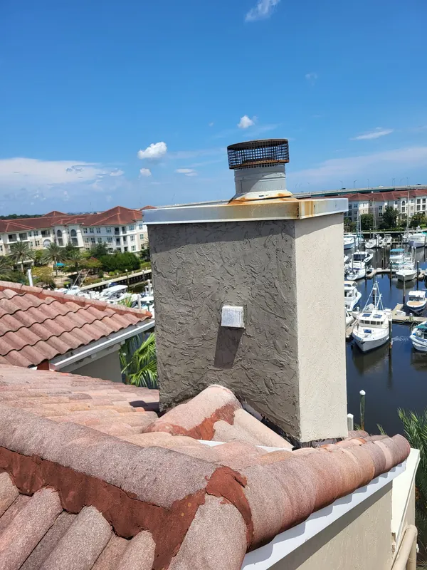 New stucco base coat applied to the chimney
