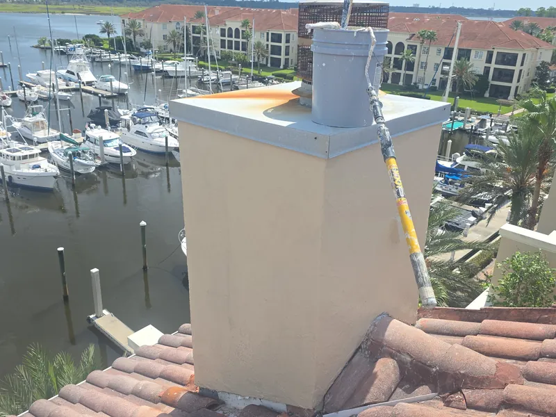 Rooftop chimney restored with new stucco and paint