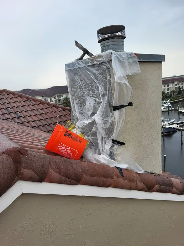 Chimney rebuild in progress, wrapped and protected