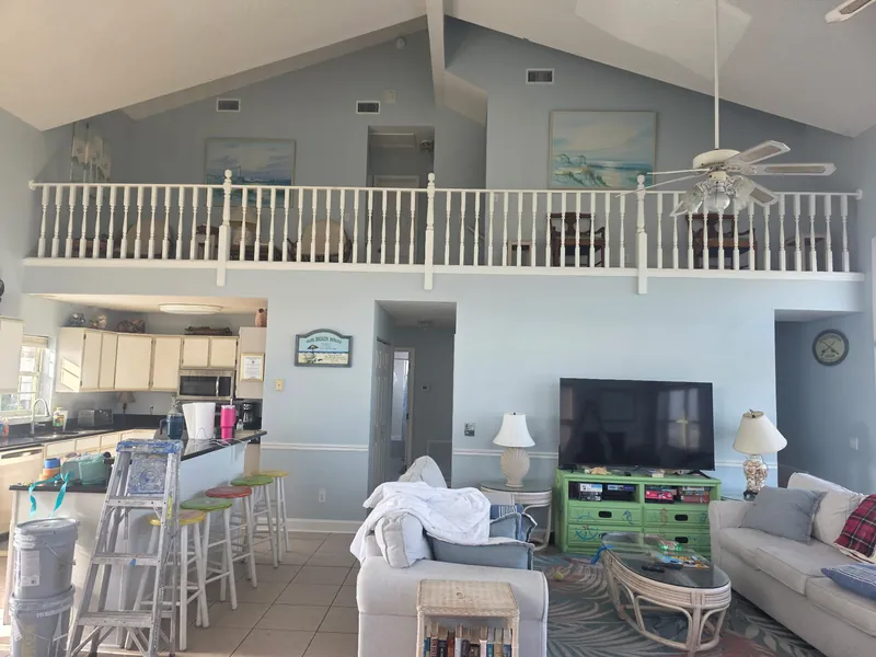 Vaulted great room and loft painted a soft coastal blue