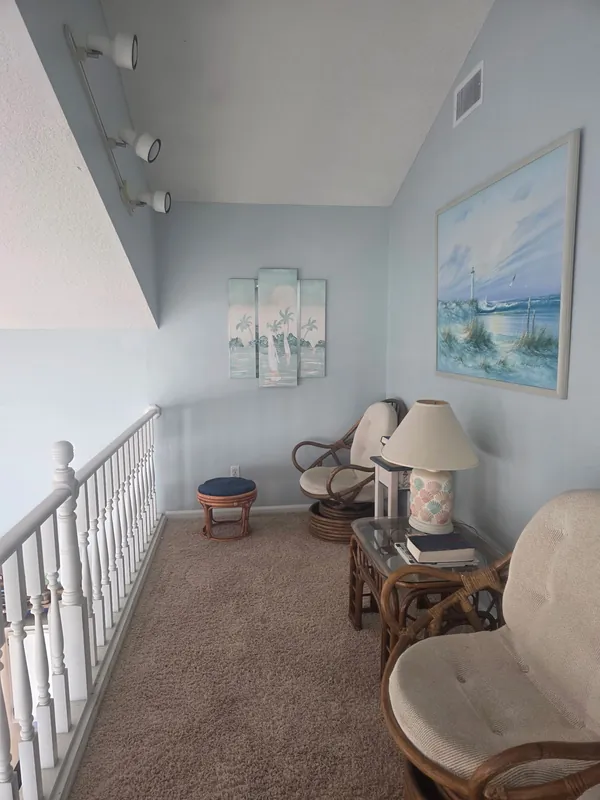 Loft sitting area with refreshed walls and white railing