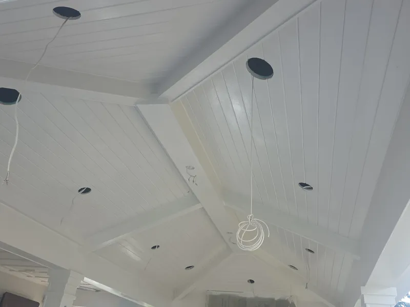 Covered porch ceiling and beams finished in clean white