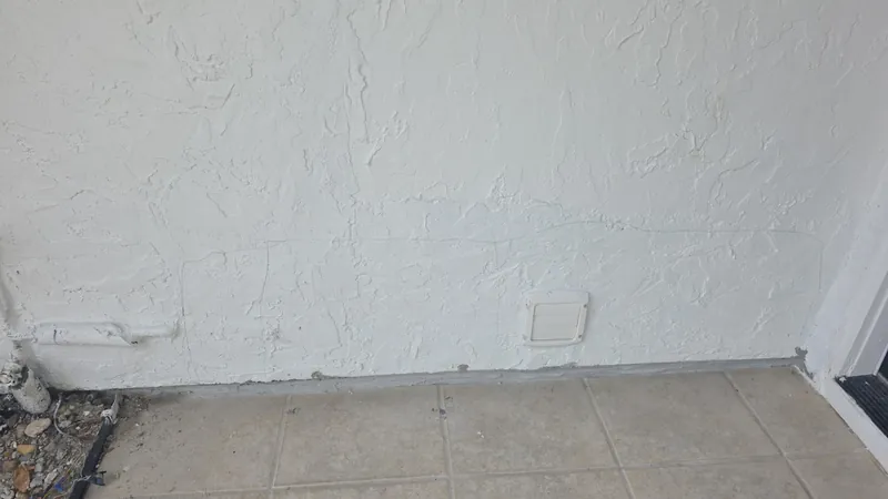Entry wall after: patched, textured, and painted to match