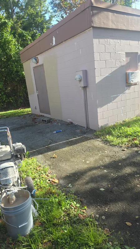 Utility building before: faded, mismatched paint